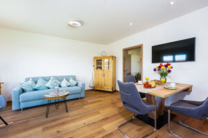 Wohnzimmer mit Blick auf Esstisch und Couch